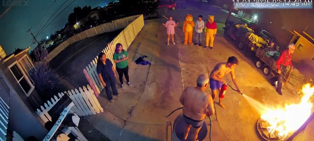 Key art for The Menace in the Backyard: the fire scene at the picket fence, the household in the driveway, captured from the security camera